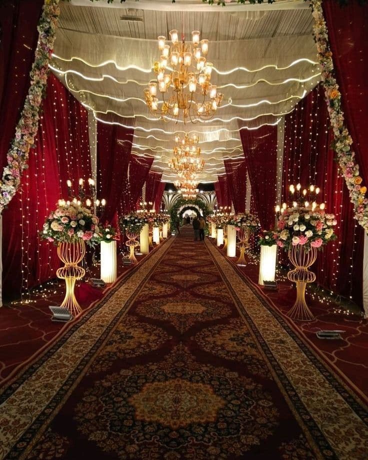 Grand wedding aisle with floral décor and chandeliers